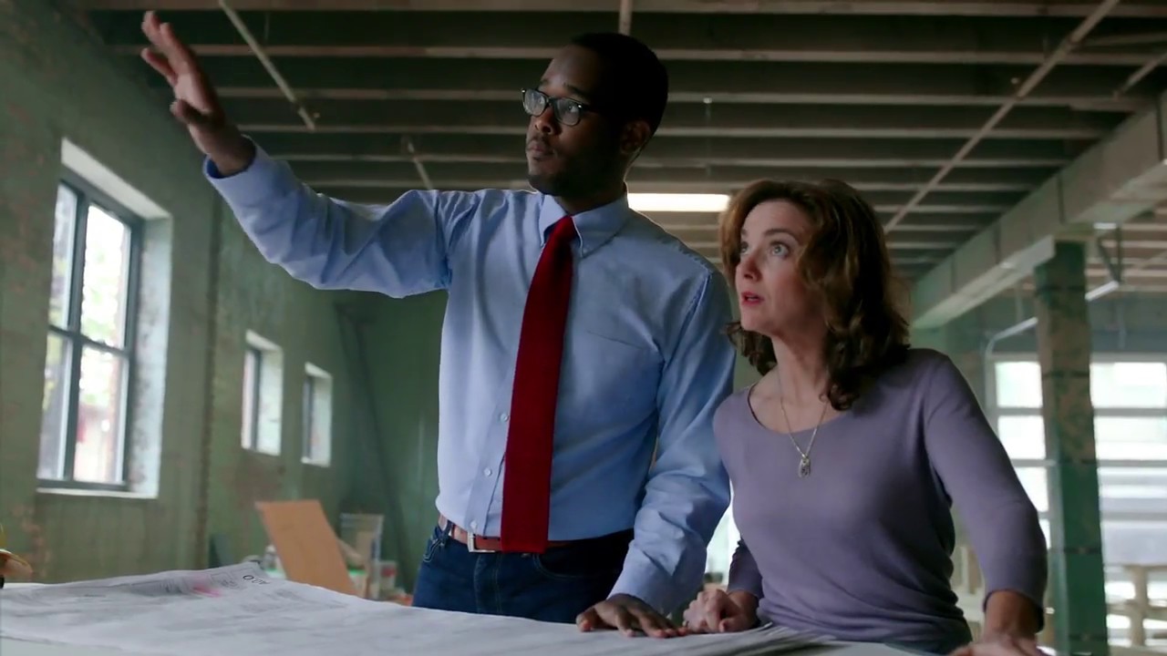 Colleagues looking over a site plan in a building undergoing construction.